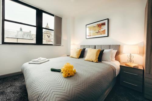 a bedroom with a bed with yellow flowers on it at Halifax House, One Bedroom Apartment 216 in Halifax