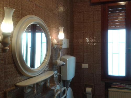 a bathroom with a sink and a mirror at B&B William in Padova