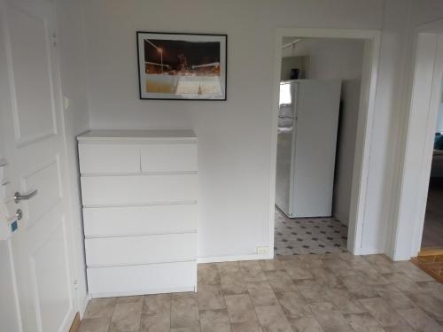 a kitchen with white drawers and a refrigerator at 43 Oscarsgate in Vadsø