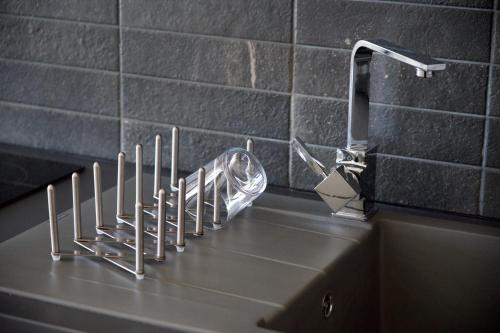 a kitchen counter with a sink with a faucet at Alancia Suites in Sami