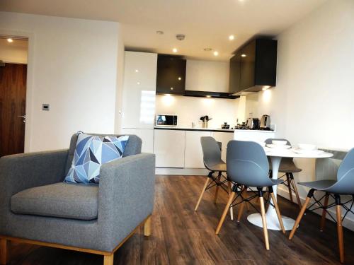 a living room with a couch and a table and chairs at Basingstoke Apartments - Downtown Luxury Apartments in Basingstoke