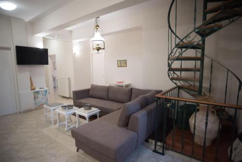 a living room with a couch and a table at Olenia Residence in Agia Pelagia