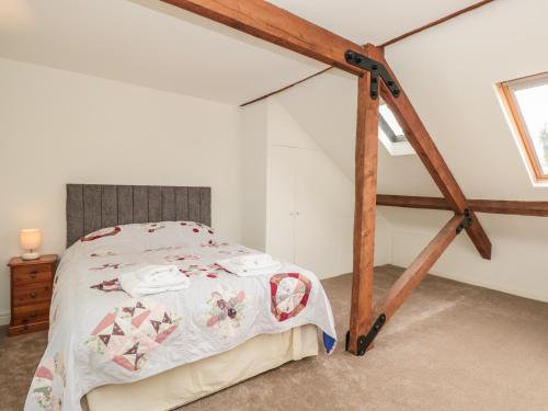 a bedroom with a bed in a attic at Lower Norton Apartment in Dartmouth