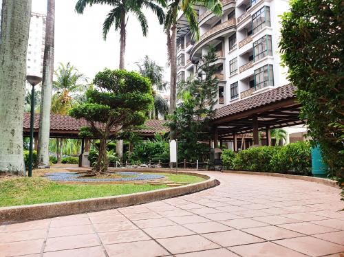 a walkway in front of a building with a fountain at Mahkota Seaview Condo Homestay Near A'Famosa jonker Melaka in Melaka