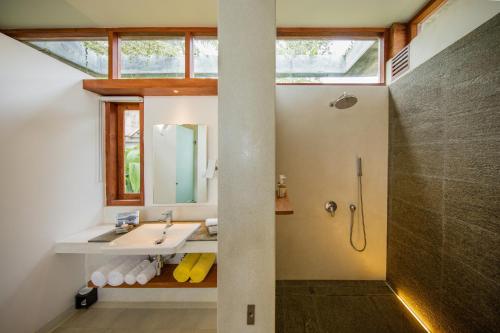 a bathroom with a sink and a shower at Tri by Amaya in Ahangama