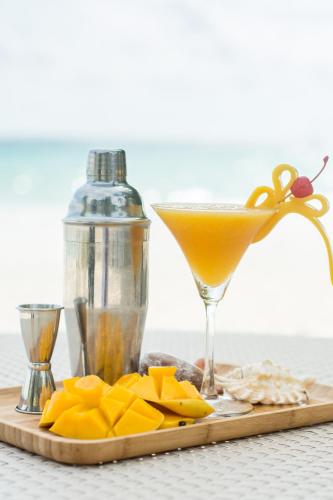 a drink in a martini glass next to pineapple slices at Sur Beach Resort Boracay in Boracay