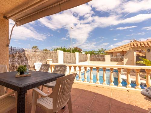 a patio with a table and chairs on a balcony at Holiday Home Fumadell by Interhome in Riumar