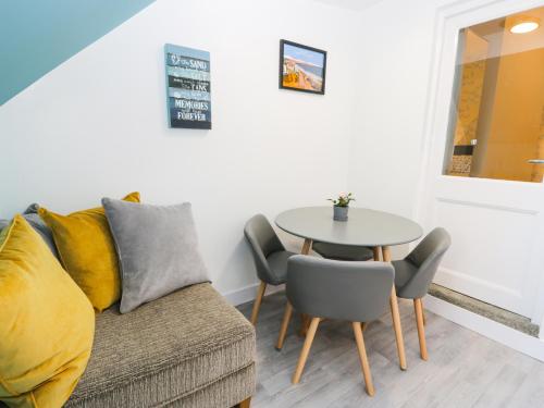 a living room with a couch and a table at Sailors Lodge in Filey