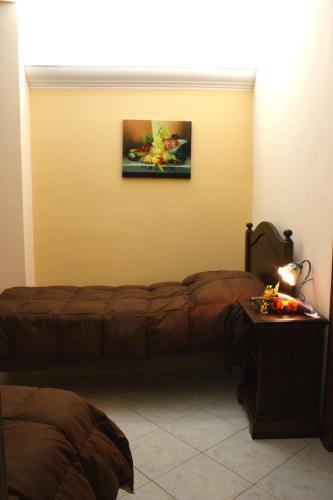 a room with two beds and a painting on the wall at Hotel Piro in Torrenova