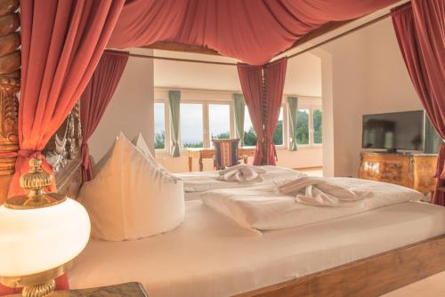 a bedroom with two beds with red curtains at Berggasthof Ziegenkopf in Blankenburg