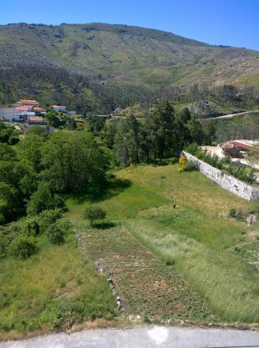 an aerial view of a field with a mountain in the background at Monte Estrela in Sabugueiro