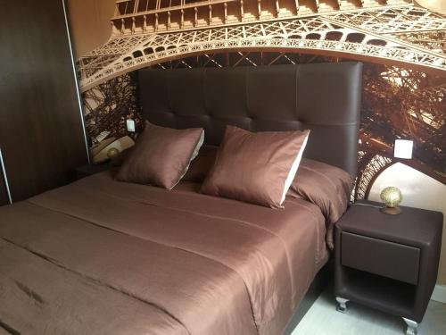 a bedroom with a bed in front of the eiffel tower at Piso cerca del Toralin y La Rosaleda in Ponferrada