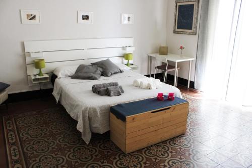 a bedroom with a large bed and a table at Gemma di Luna in Catania