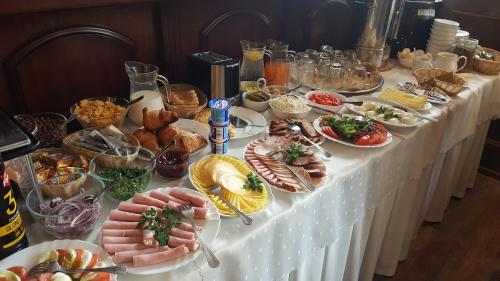 a table with many plates of food on it at Hotel Iskra in Rzeszów