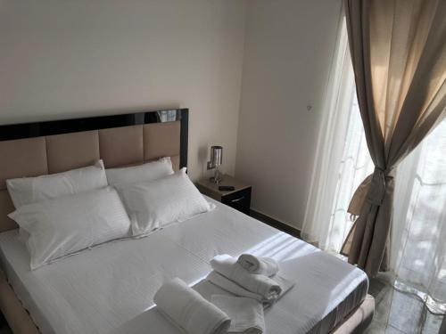 a bedroom with a bed with towels on it at Villa Anastasia Ksamil in Ksamil