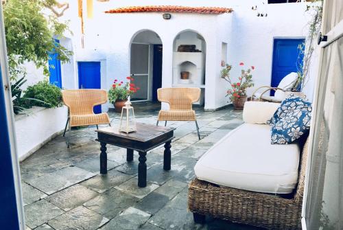 a patio with chairs and a table and a couch at Rhodes Summer House in Gennadi