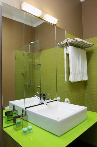a bathroom with a large white sink and green tiles at Quinta Da Pereira E Enricas Agro-Turismo in Vila Flor