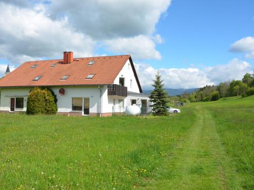 a white house with a red roof in a field at Apartment in Bohemian with Private Terrace in Dolní Lánov