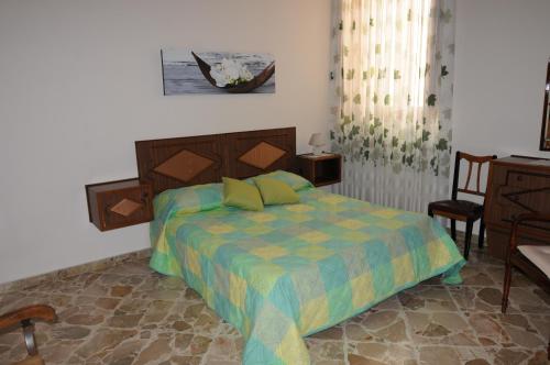 a bedroom with a bed and a table and a chair at CASA CALISI in Terrasini