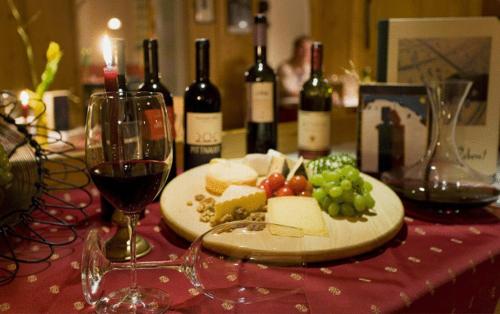 a table with a plate of food and wine bottles at Wellnesshotel Mitterwirt in Dienten am Hochkönig