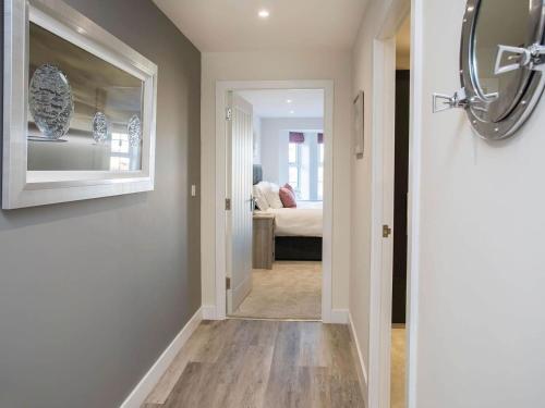 a hallway with a door leading to a bedroom at Beach Lookout in Benllech