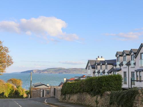 a row of houses on a street next to the ocean at Beach Lookout in Benllech