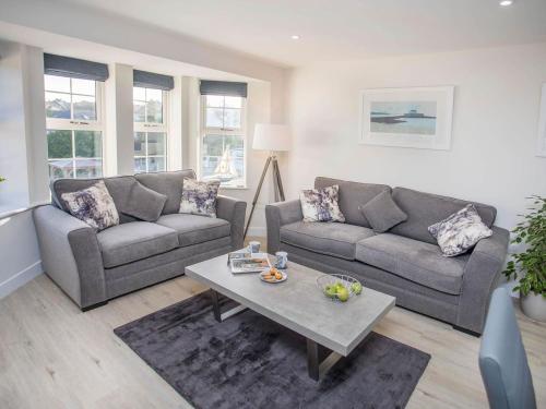a living room with two couches and a coffee table at Beach Lookout in Benllech