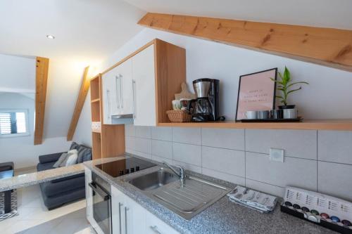 a kitchen with a sink and a counter top at Emily Apartment in Suđurađ