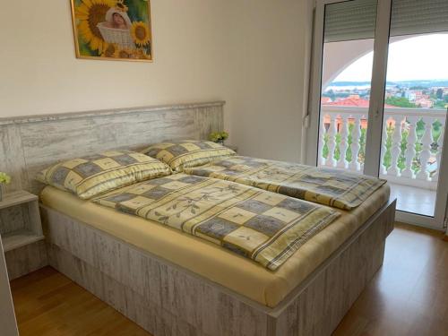 a large bed in a bedroom with a large window at Villa Natalija in Medulin