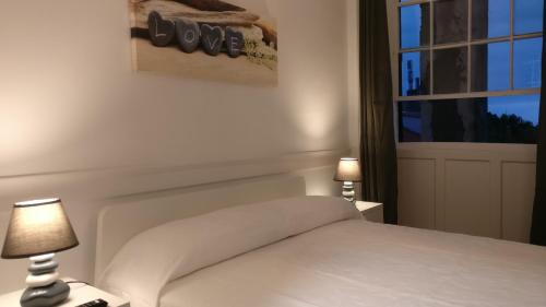 a bedroom with a white bed and two lamps at Museum House in Funchal