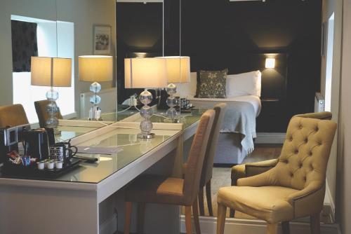 a hotel room with a desk and a bed at The Mill at Conder Green in Conder Green