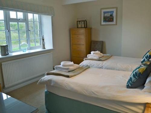 A bed or beds in a room at Port Hole 