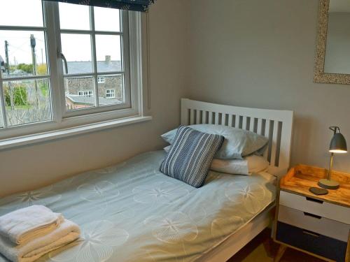 A bed or beds in a room at Port Hole 