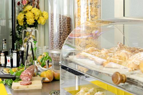 a counter filled with lots of different types of food at Hotel Carmencita in Anacapri