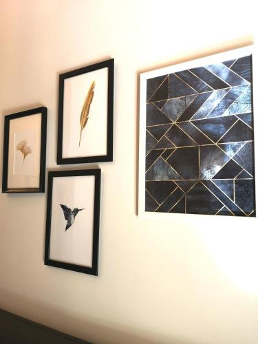 a group of framed pictures on a wall at Comfort Zone Naples in Naples