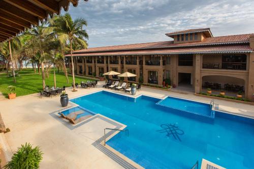 an aerial view of a resort with a large swimming pool at Marquis Beach Resort in Candolim