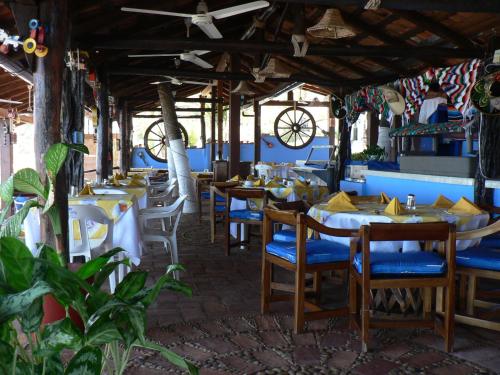 a restaurant with tables and chairs and a ceiling at Lindo Mar Resort in Puerto Vallarta