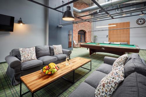 a living room with couches and a pool table at Salio Equisport Resort in Stryków