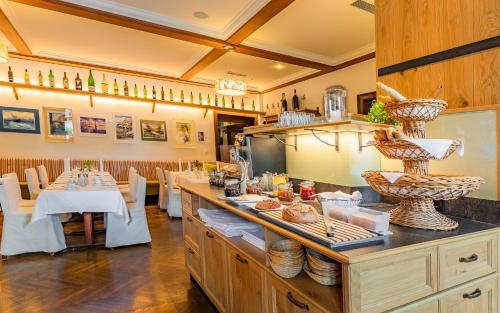 a restaurant with a counter with food on it at Hotel Post Hönigwirt in Kirchschlag