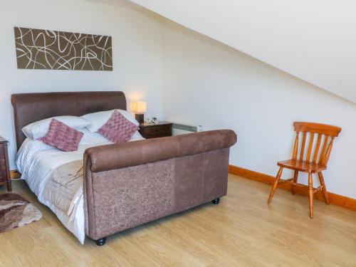 a bedroom with a couch and a table and a chair at Shorefields One in Morecambe