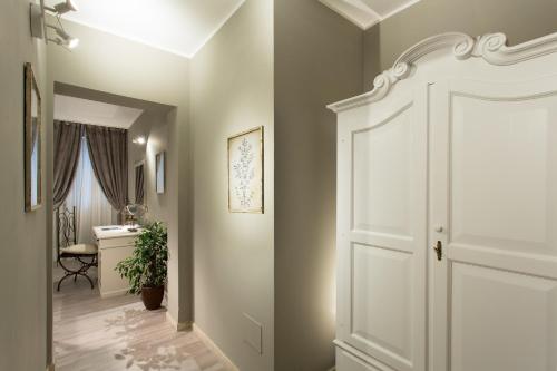 a hallway with a white door and a desk at Hotel Del Borgo in Bologna