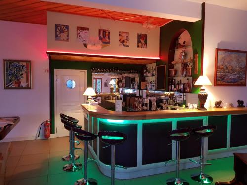 a bar in a restaurant with stools around it at Lagou Raxi Country Hotel in Lafkos