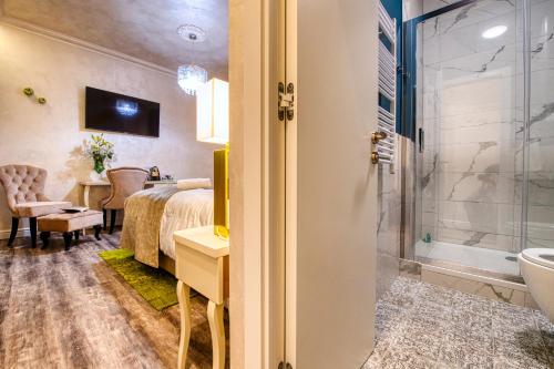 a hotel room with a bed and a bathroom at Riva Palace - design rooms in Zadar