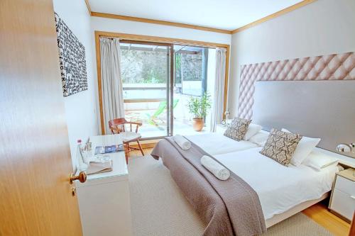 a hotel room with a bed and a window at Quinta Miramar in Funchal