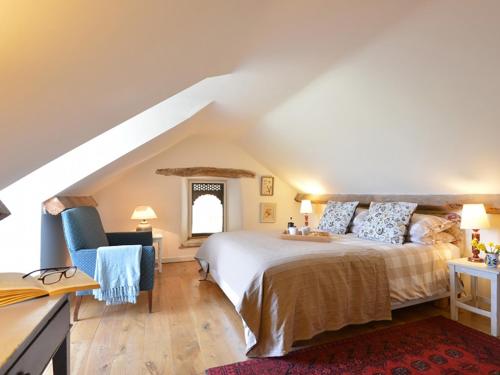 a bedroom with a bed and a desk and a chair at Cefn Isaf in Porthmadog