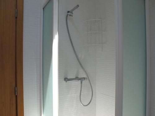 a shower with a shower head in a bathroom at Casa do Cais Cerveira in Vila Nova de Cerveira