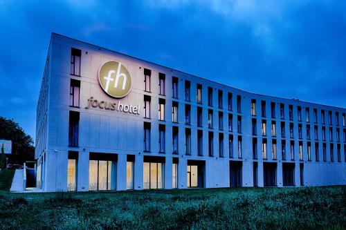 a building with a sign on the side of it at Focus Hotel Premium Lublin in Lublin