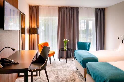 a hotel room with a bed and a desk at Focus Hotel Premium Lublin in Lublin