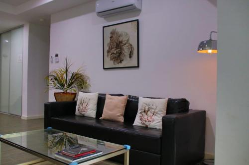 a living room with a black couch and a glass table at Elegant Design 2 Bed 2 Bath Apartment In Liverpool in Liverpool
