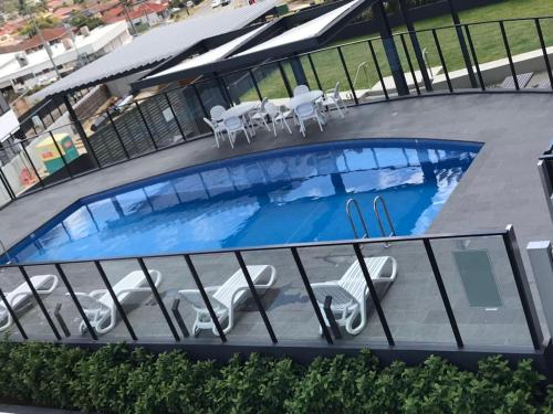 an overhead view of a swimming pool with tables and chairs at Elegant Design 2 Bed 2 Bath Apartment In Liverpool in Liverpool